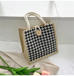 Detail of houndstooth tote bag featuring natural jute sides and woven cotton rope handles