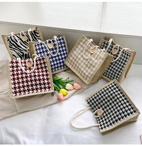 Detail shot of canvas tote bags with houndstooth patterns and wooden button accents