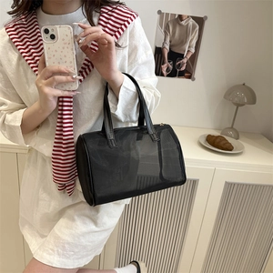 Black mesh transparent Boston handbag for women with dual leather handles in a chic setting