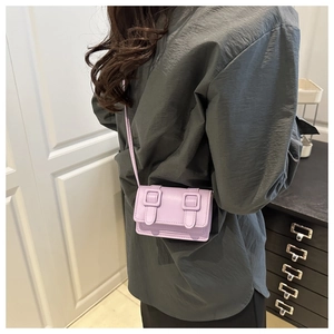 Detail view of mini purple square crossbody bag with double square buckles on stylish strap