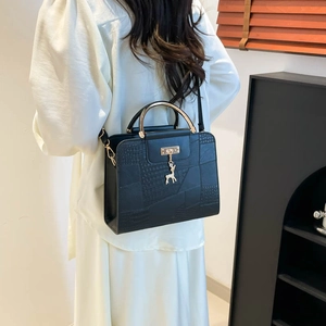 Fashionable black crocodile pattern crossbody bag with gold handle and deer pendant charm