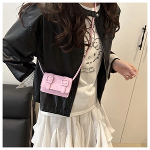 Detail of pink patent leather mini crossbody bag with double buckle and slim strap
