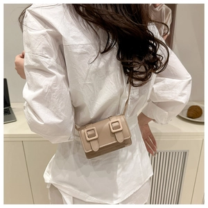 Mini coffee leather crossbody bag styled with a white shirt for a trendy summer look