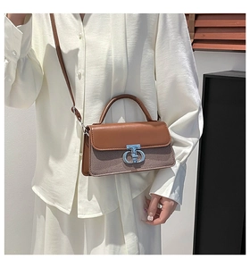 Close-up of vintage brown woven crossbody bag with silver chain buckle and leather handle