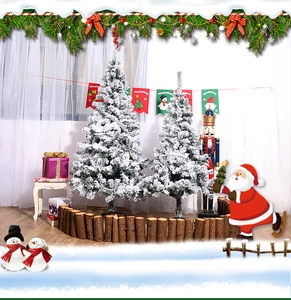 Close-up of artificial flocked Christmas trees with dense white snow coating