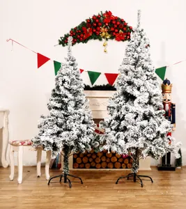 Detail of flocked Christmas trees in two sizes with snowy needles and metal stands