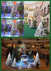 Detail of white flocked Christmas tree with snow effect on sturdy black metal folding stand