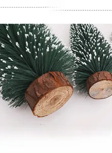 Detail of mini artificial Christmas tree with snow flocking and natural wood base