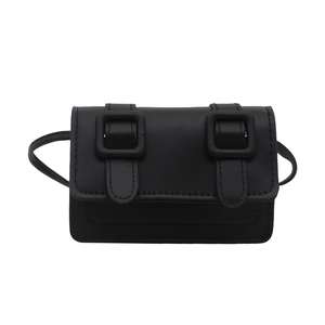 Chic black mini crossbody bag with double buckles and slim strap in minimalist style