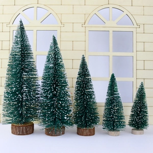 Five assorted sizes of mini flocked cedar Christmas trees with natural wood bases