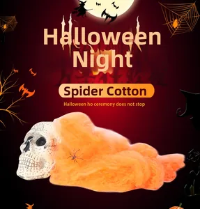 Orange spider cotton stretching over a skull for Halloween haunted house decoration
