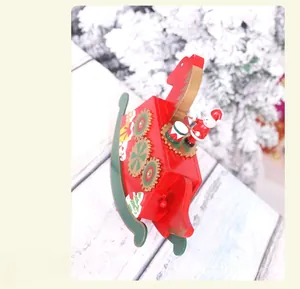 Close-up of wooden Christmas rocking horse music box with Santa playing a drum figurine