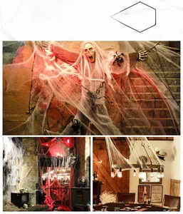 Detailed view of white spider web cotton with black spiders and skulls for Halloween decor
