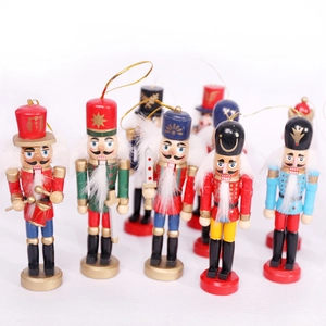 Set of handcrafted wooden Nutcracker soldier ornaments with gold hanging strings for Christmas