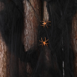 Halloween black cobweb and orange spiders on tree bark for haunted house decoration