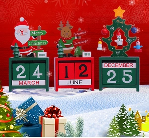 Detailed view of three wooden Christmas advent calendars with Santa and reindeer motifs