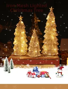 Macro detail of three gold iron mesh LED Christmas trees with warm glowing star toppers