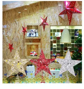 Detailed view of glittering gold, red, and silver star tree toppers with spring bases