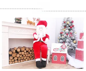 Close-up of large plush Santa Claus figurine with velvet suit for Christmas window displays