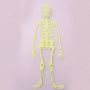 Close-up of a 32cm fluorescent green plastic skeleton prop for Halloween party decoration