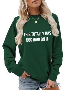Detailed view of the ribbed round neckline and white printed slogan on dark green sweatshirt