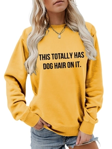 Detail of the black slogan print this totally has dog hair on it on yellow sweatshirt