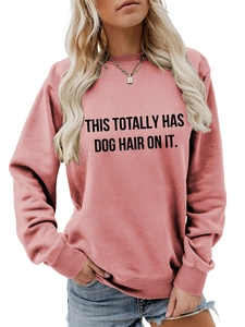 Detail of pink crewneck sweatshirt with 'THIS TOTALLY HAS DOG HAIR ON IT' print and ribbed cuffs