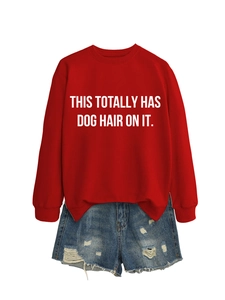 Detail of red crewneck sweatshirt with white 'THIS TOTALLY HAS DOG HAIR ON IT' print