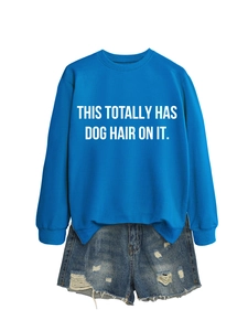 Detail of royal blue sweatshirt with white text and distressed denim shorts set