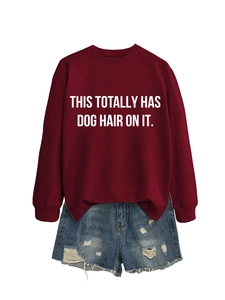 Flat lay of maroon crew neck sweatshirt with dog hair slogan and ripped denim shorts