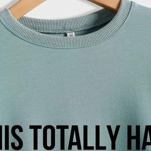 Minimalist round neck long sleeve sweatshirt in pale green with custom black lettering