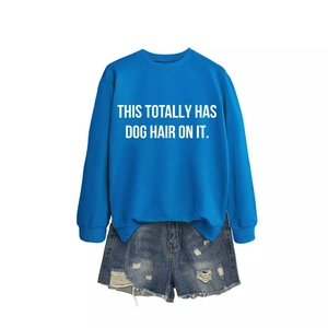 Blue crewneck sweatshirt with dog hair quote paired with distressed denim shorts