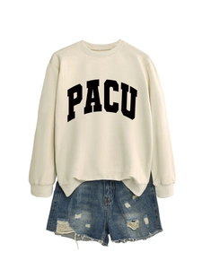 Detail of cream sweatshirt with black PACU letter print and frayed denim shorts