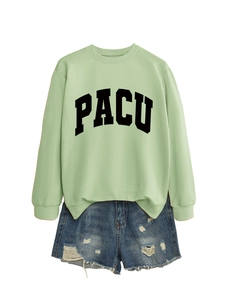 Detailed flat lay of green crewneck sweatshirt with PACU print and ripped denim shorts