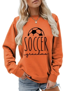 Detail of Soccer Grandma print on an orange crewneck sweatshirt with ribbed collar