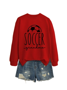Flat lay of a red long-sleeve soccer grandma sweatshirt with distressed denim shorts