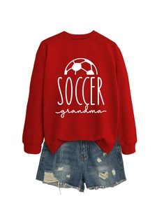 Close-up of Soccer Grandma graphic print on red long sleeve sweatshirt with denim shorts