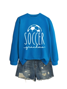Close-up of Soccer Grandma printed blue sweatshirt and distressed denim shorts on white background