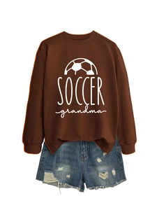Detail view of Soccer Grandma brown sweatshirt with side slits and distressed denim shorts