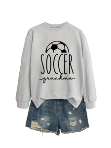Flat lay of gray soccer grandma sweatshirt paired with distressed denim shorts