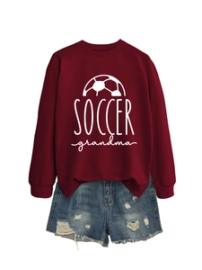 Detail of Soccer Grandma print on a dark red crewneck sweatshirt with white football graphics