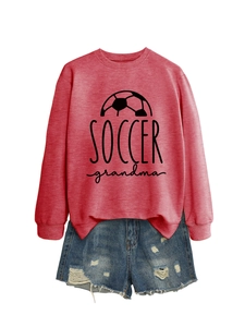 Detail of red Soccer Grandma sweatshirt paired with distressed blue denim shorts