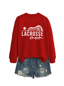Detail of red Lacrosse Mom crewneck sweatshirt with white printed graphic and denim shorts