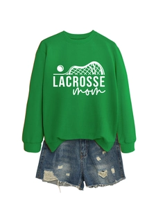 Detail of green Lacrosse Mom sweatshirt with white graphic print and denim shorts