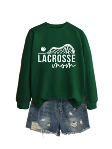 Detail of Lacrosse Mom graphic print on a dark green crewneck sweatshirt and denim shorts