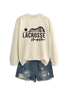 Close-up of beige Lacrosse Mom sweatshirt fabric texture and printed black lettering