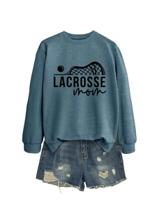 Detail of blue Lacrosse Mom sweatshirt with ribbed cuffs and matching denim shorts