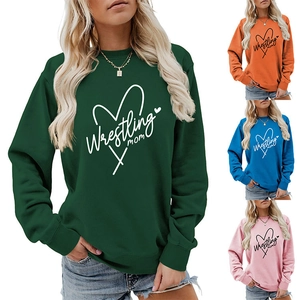 Detail view of Wrestling Mom crewneck sweatshirts in dark green, orange, blue, and pink