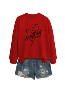 Detail of red Wrestling Mom sweatshirt paired with distressed blue denim shorts on white background