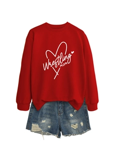 Close-up of a red Wrestling Mom sweatshirt paired with distressed blue denim shorts